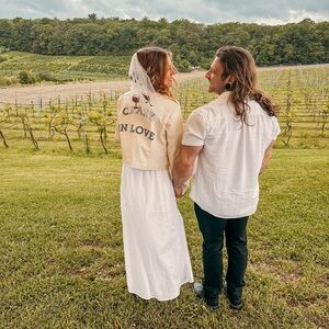 A faux leather bridal jacket says “crazy in love” on the back